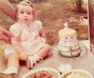 Beth Pizio with a cake her mother decorated for Beth’s 1st birthday
