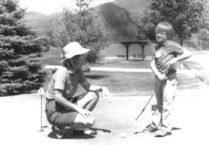Sarah Hunter teaching a young golfer.