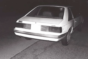 Rear view of Kathy Perry’s Mercury Capri on the side of the road where it was abandoned.