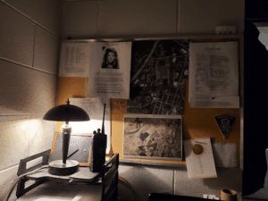 Scene from Sgt. Pierce’s desk with Kathy’s photo and aerial view of key case locations.