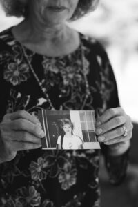 Michelle holds a photo of young Chrissy