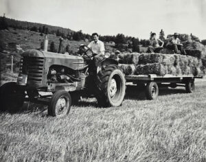 Hauling hay with his family on the family farm.