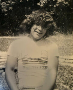 Phil and his curly hair, as his sister remembers him.